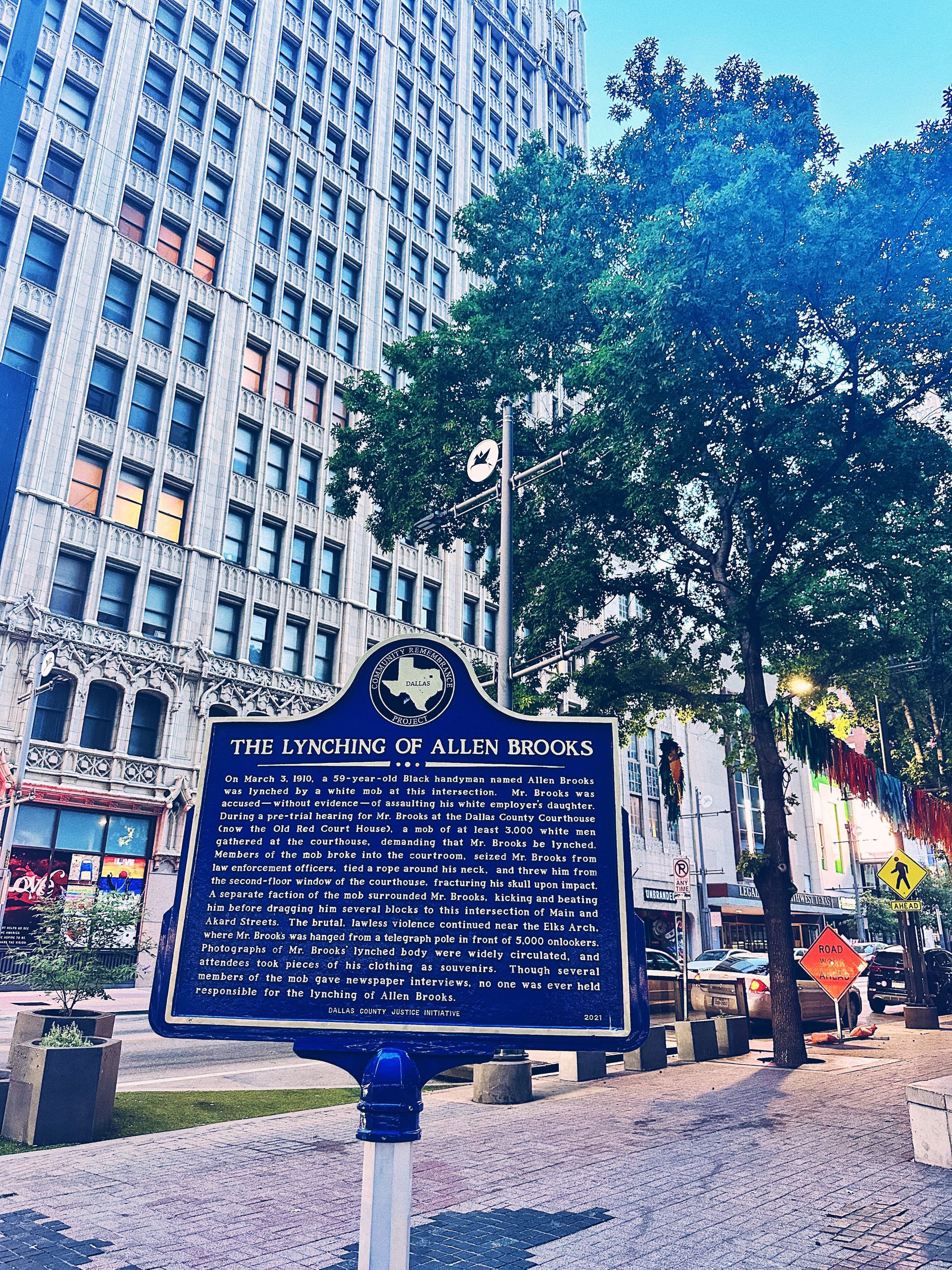 Looking up at memorial historical marker for The Lynching of Allen Brooks in Downtown Dallas, TX