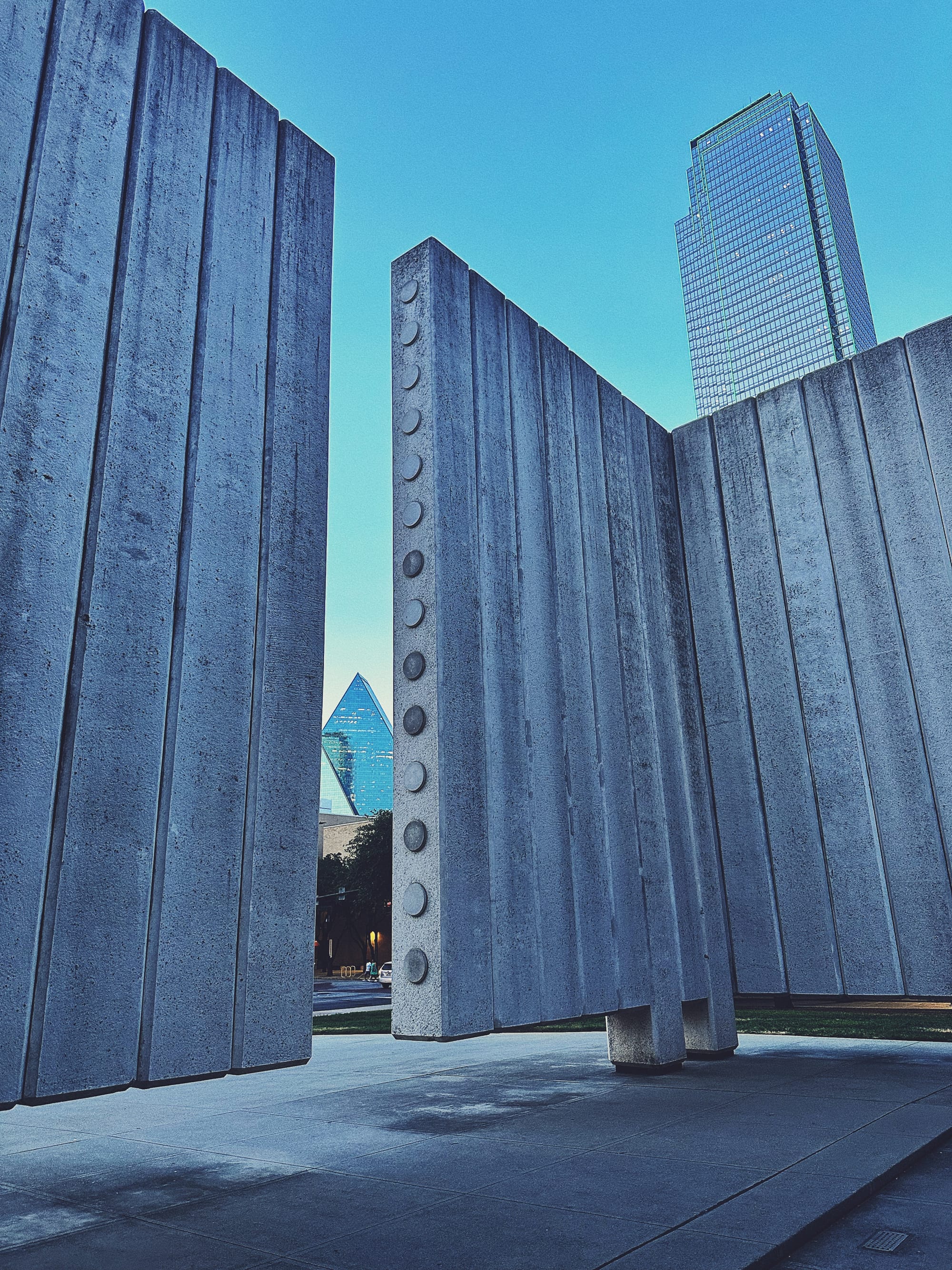 Inside the JFK Memorial in Downtown Dallas, TX, looking out towards Fountain Place and the Bank of America building.